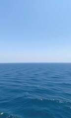 Obraz premium Vast, seamless expanse of tranquil blue sea meeting a clear, bright sky, creating a serene horizon, ocean, travel, horizon