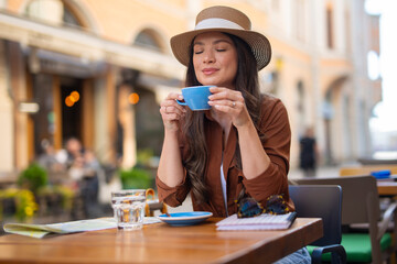 Woman enjoying coffee mug at outdoor cafe travel