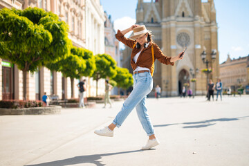 Woman dancing happily in novi sad city square © Dexon Dee