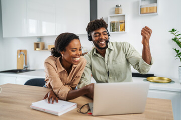 Couple collaborating on remote work using laptop and headset