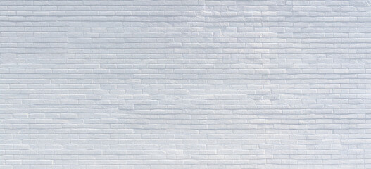 White and gray painted brick wall texture with horizontal elongated blocks. Clean minimalist surface for interior design, architectural backgrounds and urban aesthetics.

