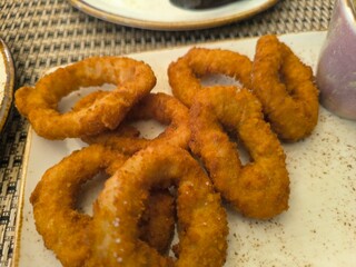 Close-up of baked squid rings in plate on table