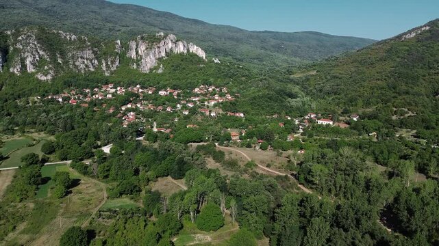 Aerial drone view of a traditional Serbian village with red-roof houses near Jerma Canyon. Horizontal 4k footage