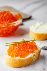 Sandwich with red caviar and soft cheese preparation process