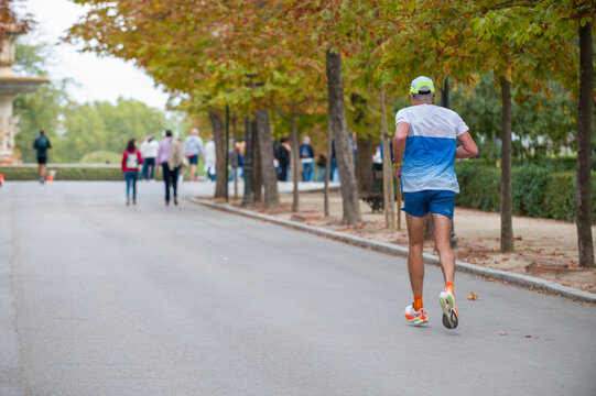 Back view of a jogger elder man running - Powered by Adobe