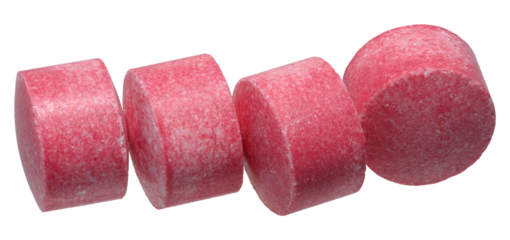 Cylindrical pink tablets in a row, isolated background