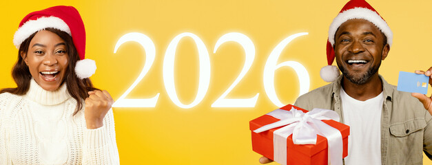 Two happy individuals celebrate the arrival of New Year 2026. They are wearing festive Santa hats, showing excitement and holding a gift box. A bright yellow background enhances the festive mood.