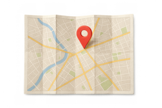 Folded map with red location pin marking a destination, showing navigation, travel planning, and route guidance