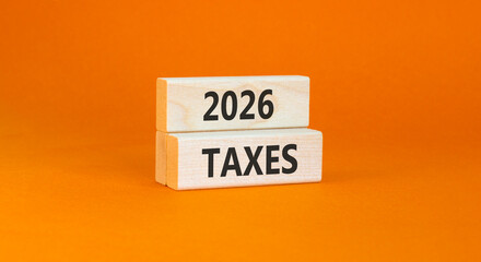 2026 taxes new year symbol. Concept words 2026 taxes on beautiful wooden blocks. Beautiful orange paper background. Business and 2026 taxes new year concept. Copy space.