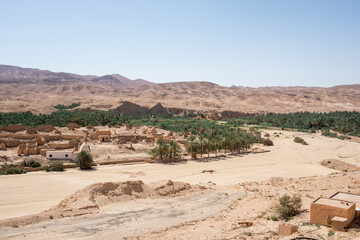 Aerial view of ruins of of Tamerza or Tamaghza, and palm forest around. Tunisia.