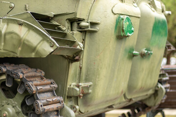 Tank side with open hatches. Side profile of a green tank featuring open hatches and vents, rusty...