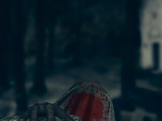Zombie head covered with light sheet of fabric with red spot of blood resting its hand on gravestone with unfocused background