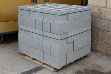 Constructions material, stack of textured  concrete blocks  ready for transport and use in large-scale construction.