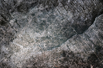 Dark-gray grainy rock surface with diagonal micro-cracks, granite-like. High-contrast grunge...