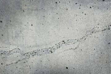 Light gray concrete wall with a thin curved crack. Natural grunge stone texture and background for posters, banners and typography.