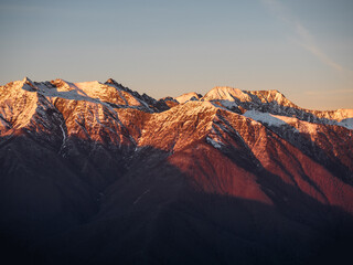 Winter mountain landscape, snowy peaks on sunset
