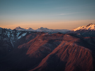 Winter mountain landscape, snowy peaks on sunset
