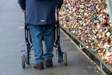 Obraz premium a man with rollators walk across the Hohenzollern Bridge, Cologne