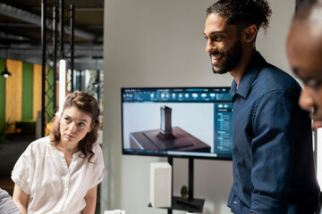 Fototapeta premium Property development team evaluating 3D models structural layout for a housing project focused on sustainability and urban infrastructure growth. Modern briefing meeting for site construction.