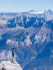 Hiker Standing on Pointe Percée Summit Overlooking Aravis Mountains