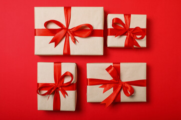 Gift Boxes with Red Ribbons on Red Background. Flat Lay Holiday Concept