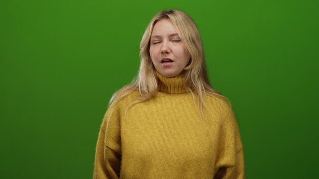 Woman in yellow sweater making expressions against a solid green background showing various moods in a minimalist setup
