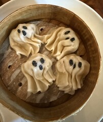 Spooky Halloween dim sum with ghost faces