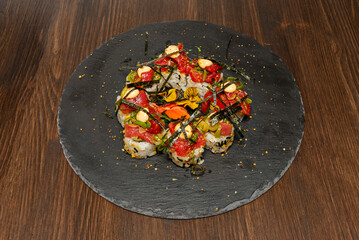 Tuna and mango uramaki with lime and cilantro, presented on porcelain with Japanese motifs