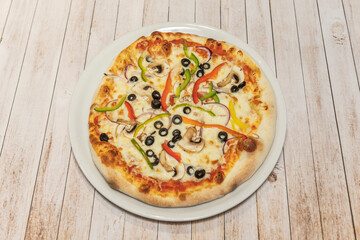 Vegetarian pizza with roasted peppers, grilled eggplant, caramelized onions, and fresh spinach on a whole-wheat crust