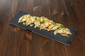 Fried dumplings filled with pork, kale, and shitake, served with black rice vinegar