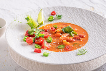 Professional Thai soup with high-end presentation on plate.