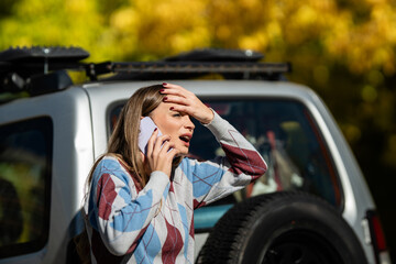 Woman calling for help with car breakdown