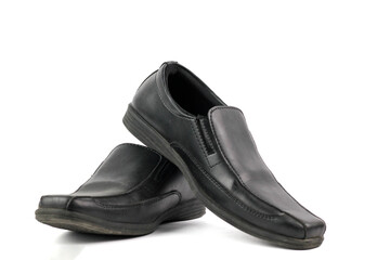 pair of elegant and simple black leather loafer shoes for man isolated on a white background