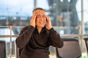 Sick unhappy senior man touching head serious depressed feeling headache thinking of problem,...