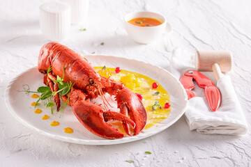 Elegant steamed lobster with orange and butter sauce.