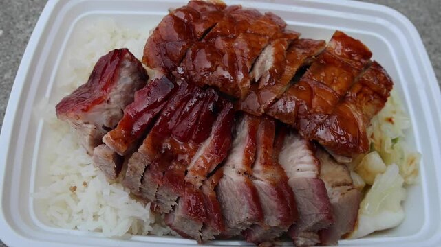 chinese food takeout lunch container with roast duck and glazed pork meat over white rice with cabbage (asian meal plastic) delicious bbq barbecue sweet sour combo platter cut sliced 