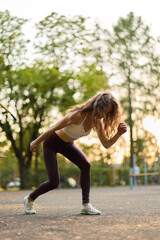 Fototapeta premium Engaging in Dynamic Fitness Training at an Urban Park during a Beautiful Sunset Hour