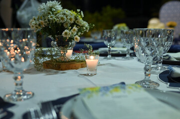 buffet table with dishes, candles, arrangements and wedding dinner decoration
