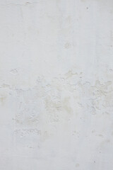 Textured white wall with peeling paint, showcasing a weathered surface, subtle variations in tone, and a minimalist aesthetic, ideal for backgrounds and design projects
