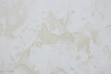 Textured white wall with peeling paint, showcasing layers of wear and age, creating a rustic and weathered appearance, ideal for backgrounds and artistic projects