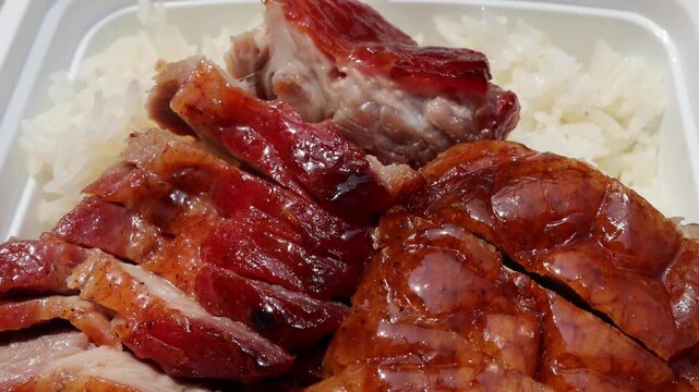 chinese food takeout lunch container with roast duck and glazed pork meat over white rice with cabbage (asian meal plastic) delicious bbq barbecue sweet sour combo platter cut sliced 