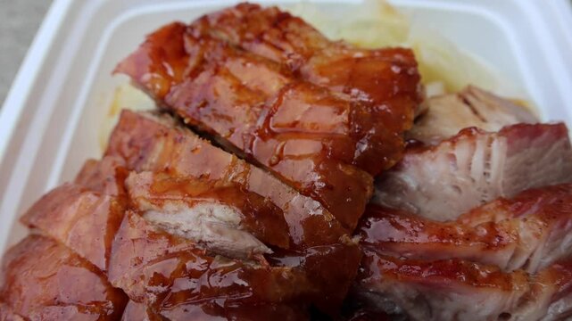 chinese food takeout lunch container with roast duck and glazed pork meat over white rice with cabbage (asian meal plastic) delicious bbq barbecue sweet sour combo platter cut sliced 