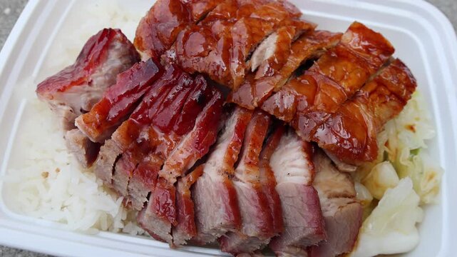 chinese food takeout lunch container with roast duck and glazed pork meat over white rice with cabbage (asian meal plastic) delicious bbq barbecue sweet sour combo platter cut sliced 