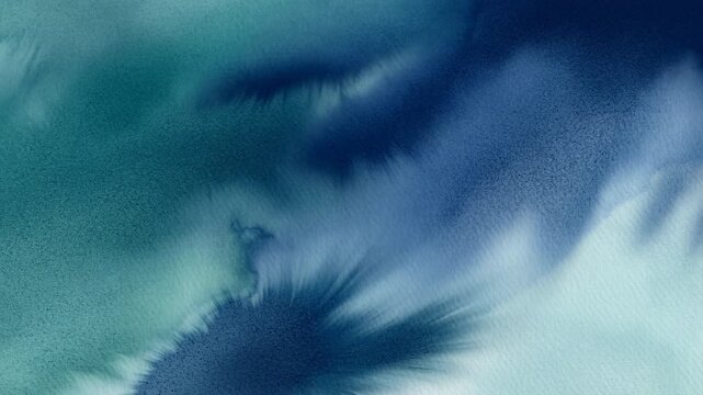Blue and green watercolor ink spreading on paper
