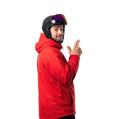 Fototapeta premium Playful young adult man in winter sports gear, including a red jacket and ski helmet with goggles, making a finger gun gesture against a transparent background.