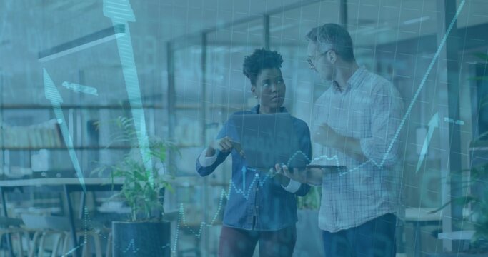 Colleagues reviewing digital data in open plan office, with tablet stylus and clipboard - Powered by Adobe