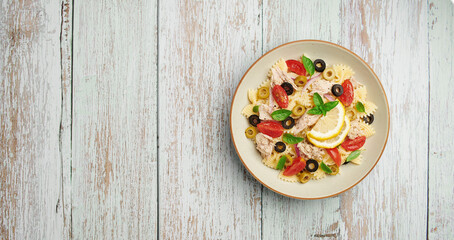 Tuna Pasta Salad on wooden background, top view copy space 