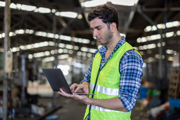 Factory male worker. Engineer man worker working with labtop checking working in industrial manufacturing factory, men at work to checking equipment of machinery production technology or construction.