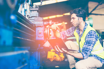 Factory male worker. Engineer man worker working with labtop checking working in industrial manufacturing factory, men at work to checking equipment of machinery production technology or construction.