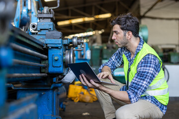 Factory male worker. Engineer man worker working with labtop checking working in industrial manufacturing factory, men at work to checking equipment of machinery production technology or construction.